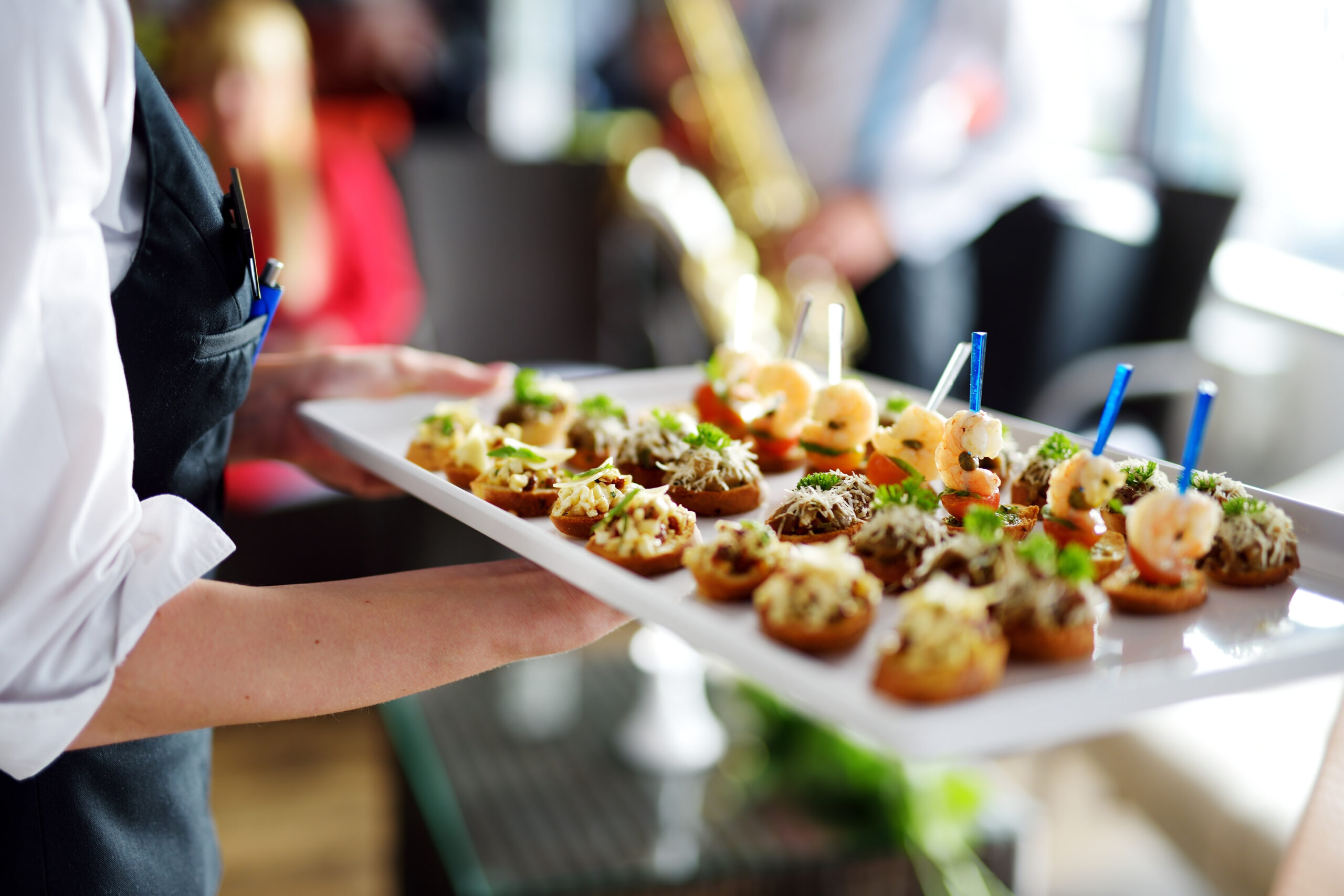 Waiter carrying plates with meat dish