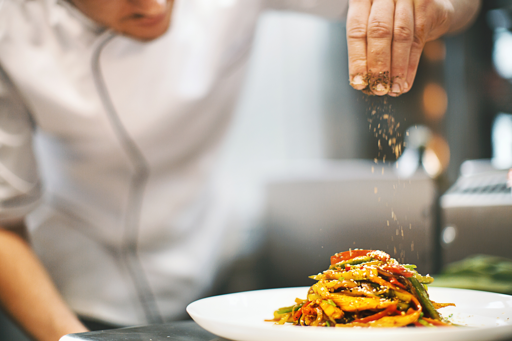 Sprinkling seasonings from high up.