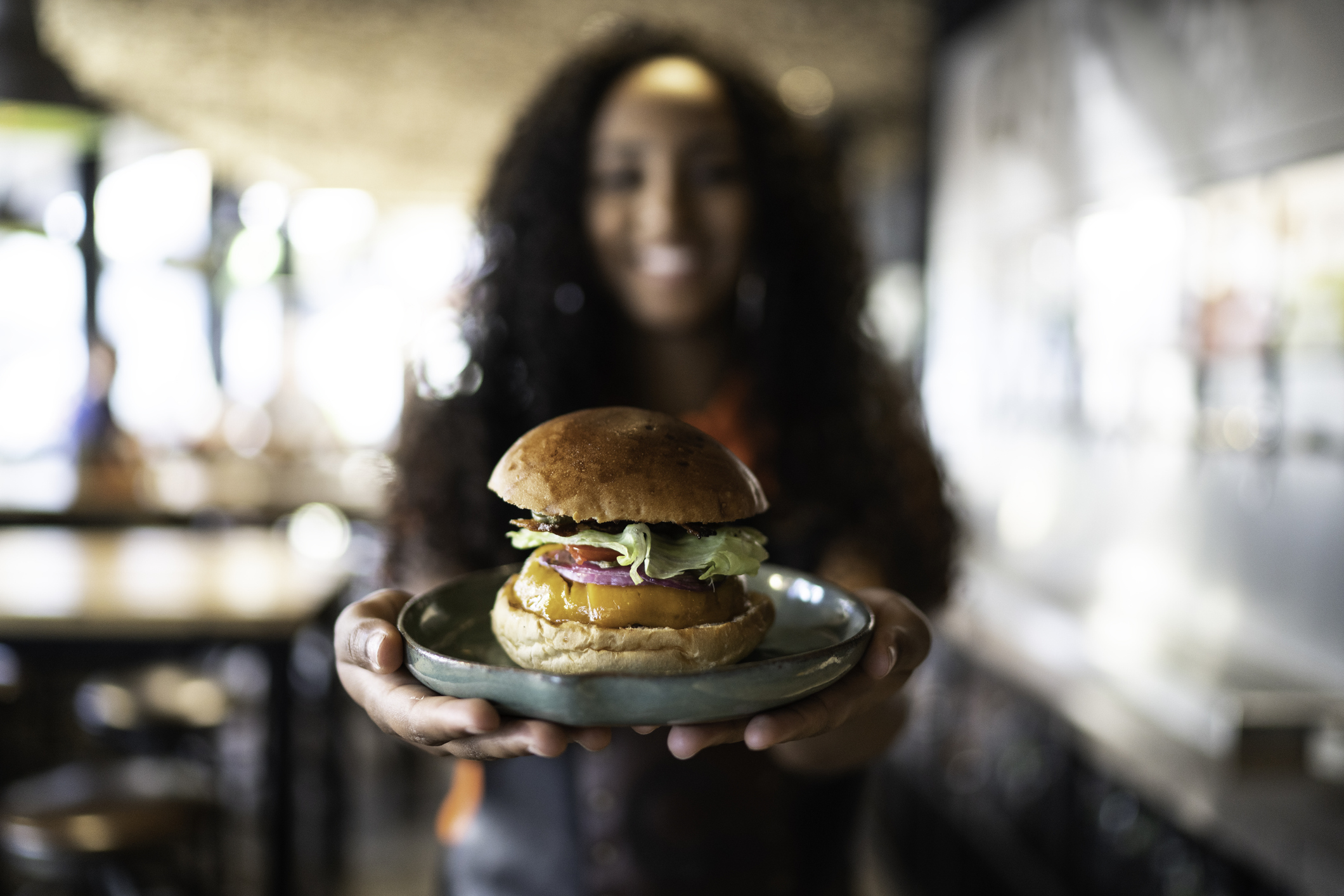 Waitress holding / showing a sandwich Waitress holding / showing a sandwich