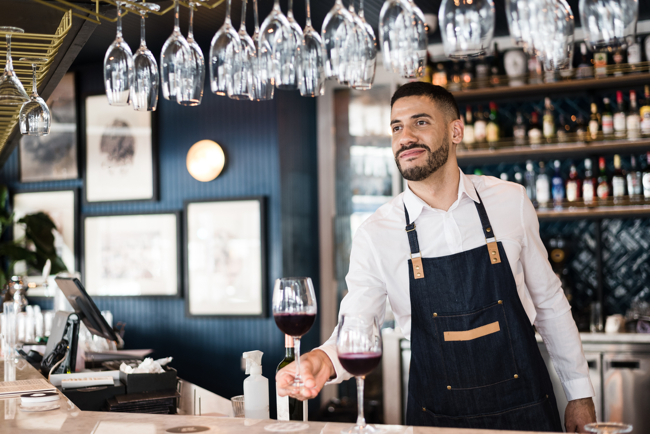 Bartender offering a glass of wine