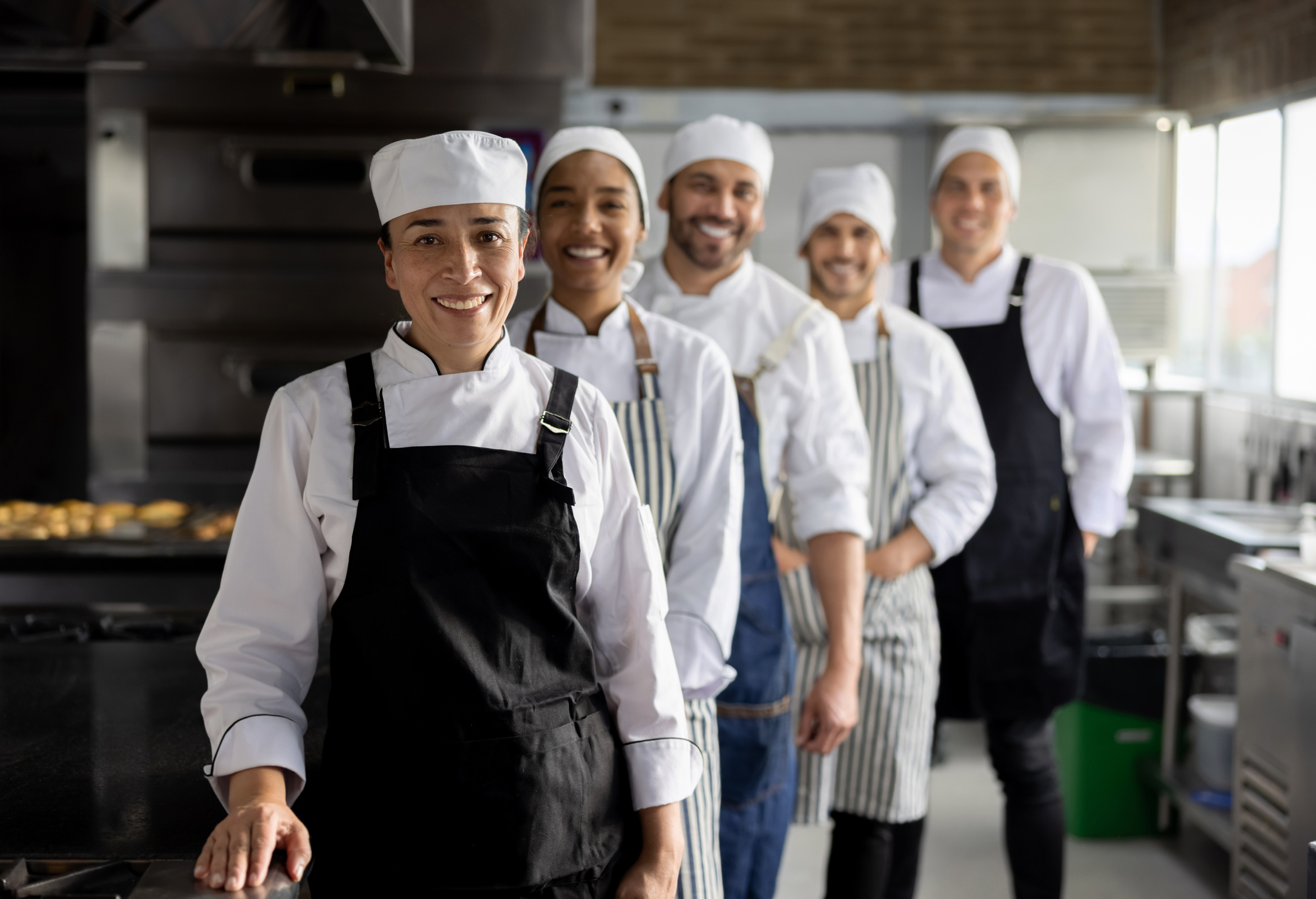 Happy group of bakers working at a bakery