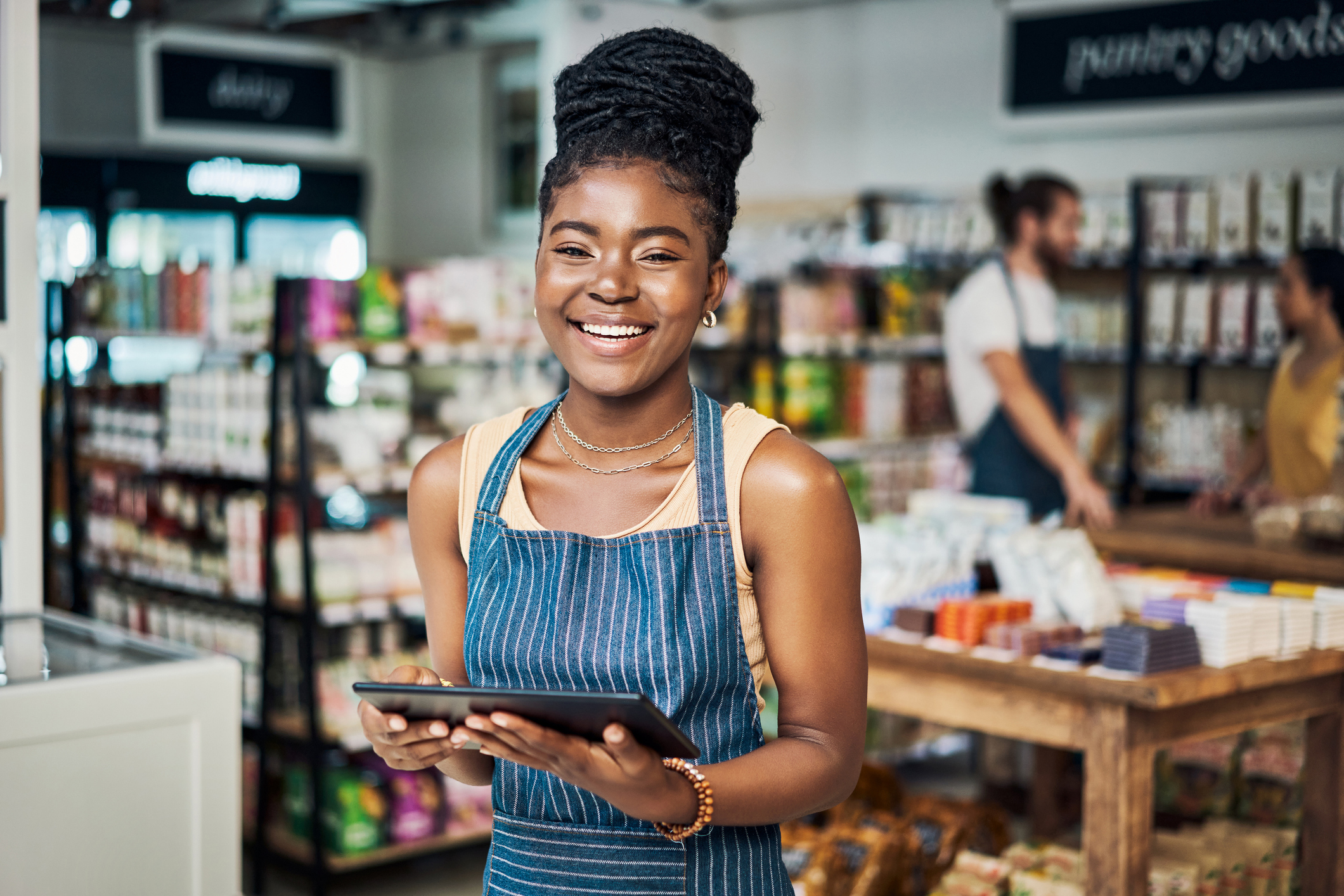 Shot of a young woman using a digital tablet while working in an organic store Shot of a young woman using a digital tablet while working in an organic store