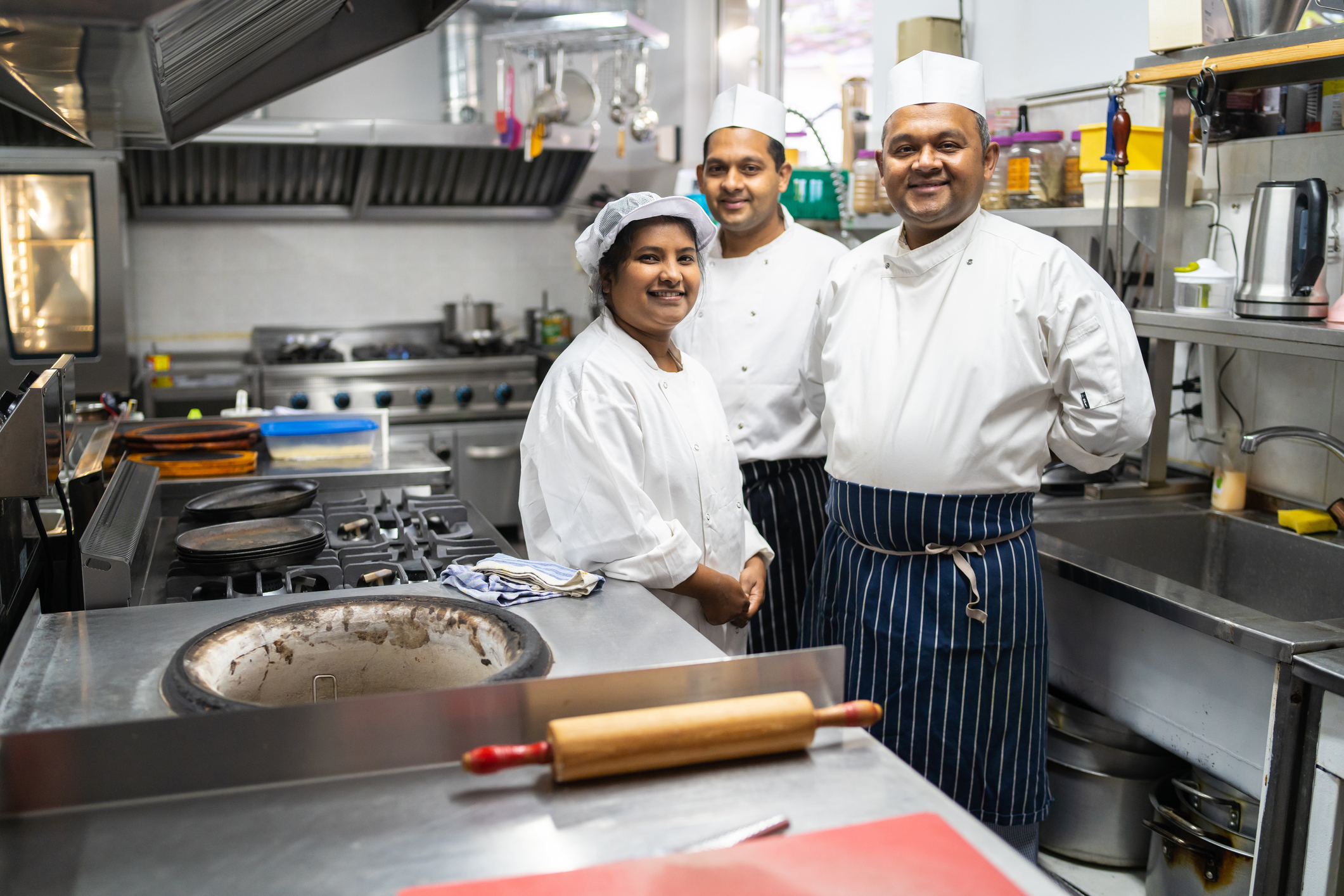 A group of chefs in an industrial kitchen